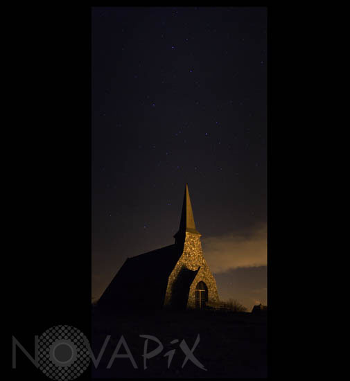 Starry sky above a church in Etretat