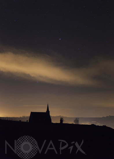 Starry sky above a church in Etretat