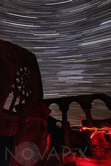 Star trails above an old chapel
