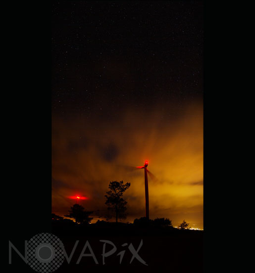 Starry sky, clouds and wind turbines